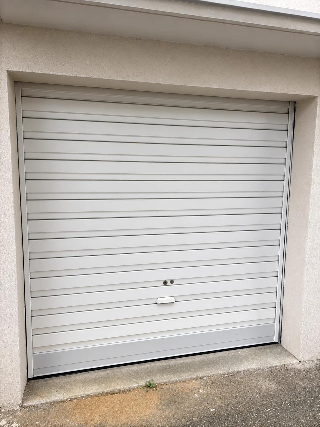 Porte de garage enroulable parfaitement fonctionnelle après remplacement de la motorisation par MGParis à Saint-Brice-sous-Forêt (95350).
