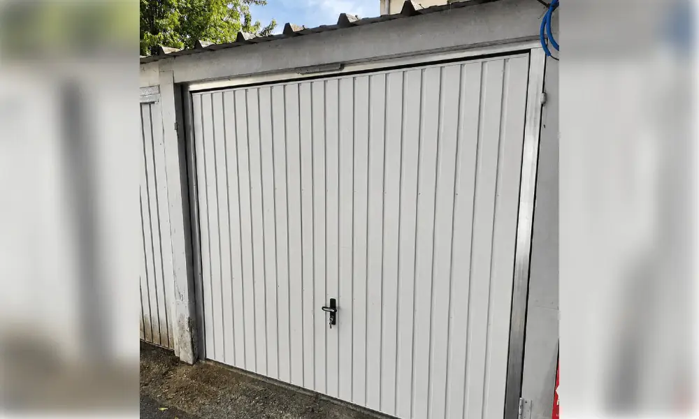 Porte de garage basculante blanche à rainures verticales et poignée noire, box à Chailly-en-Bière